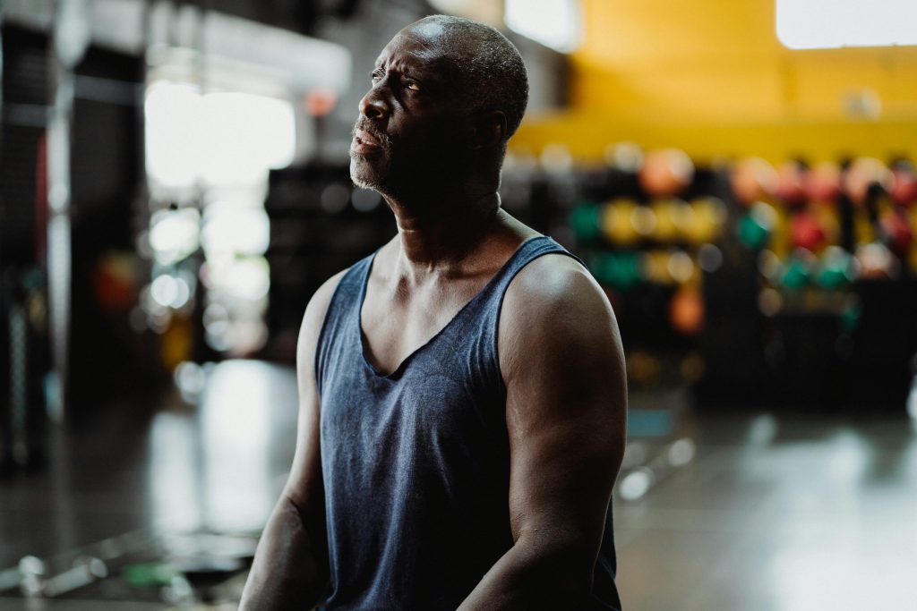 Man sitting down and looking pensively at the ceiling.